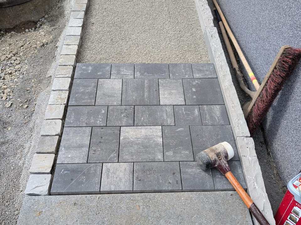 Neue Natursteinmauer mit Zaun entlang der Straße in Kassel